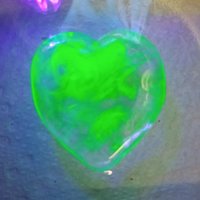 My Wispy Heart Glows! Uranium Large Heart  1" (25mm) clear glass with uranium swirls; This pocket heart is perfect for gift or curio display