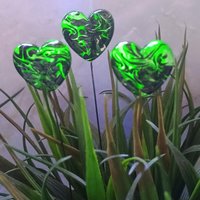 Uranium vasoline glass heart plant pick with black swirls on 5in wire. Use for floral bouquet, plants, jewelry, gifts; handmade by me; 395nm