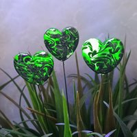 Uranium vasoline glass heart plant pick with black swirls on 5in wire. Use for floral bouquet, plants, jewelry, gifts; handmade by me; 395nm