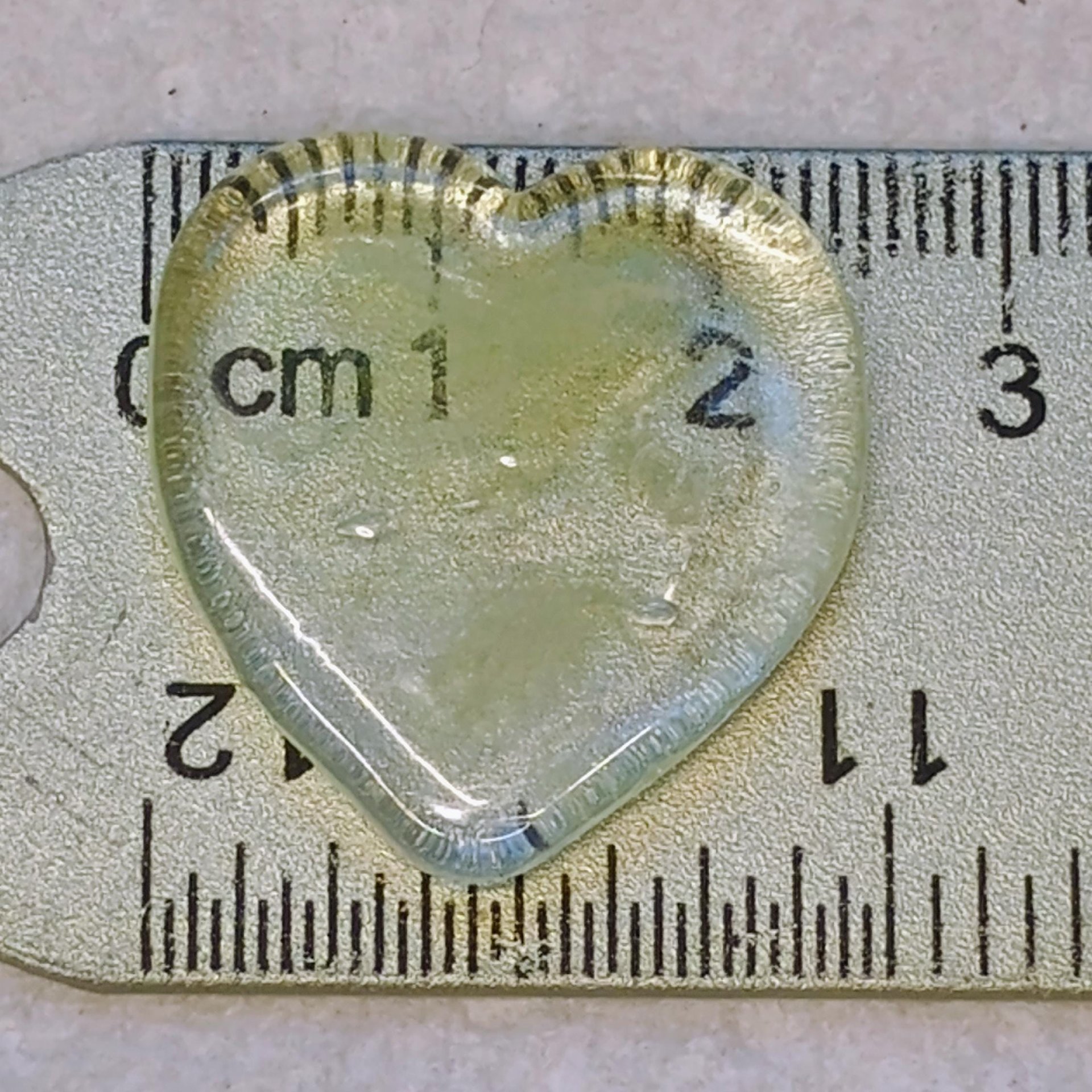 My Wispy Heart Glows! Uranium Large Heart  1" (25mm) clear glass with uranium swirls; This pocket heart is perfect for gift or curio display