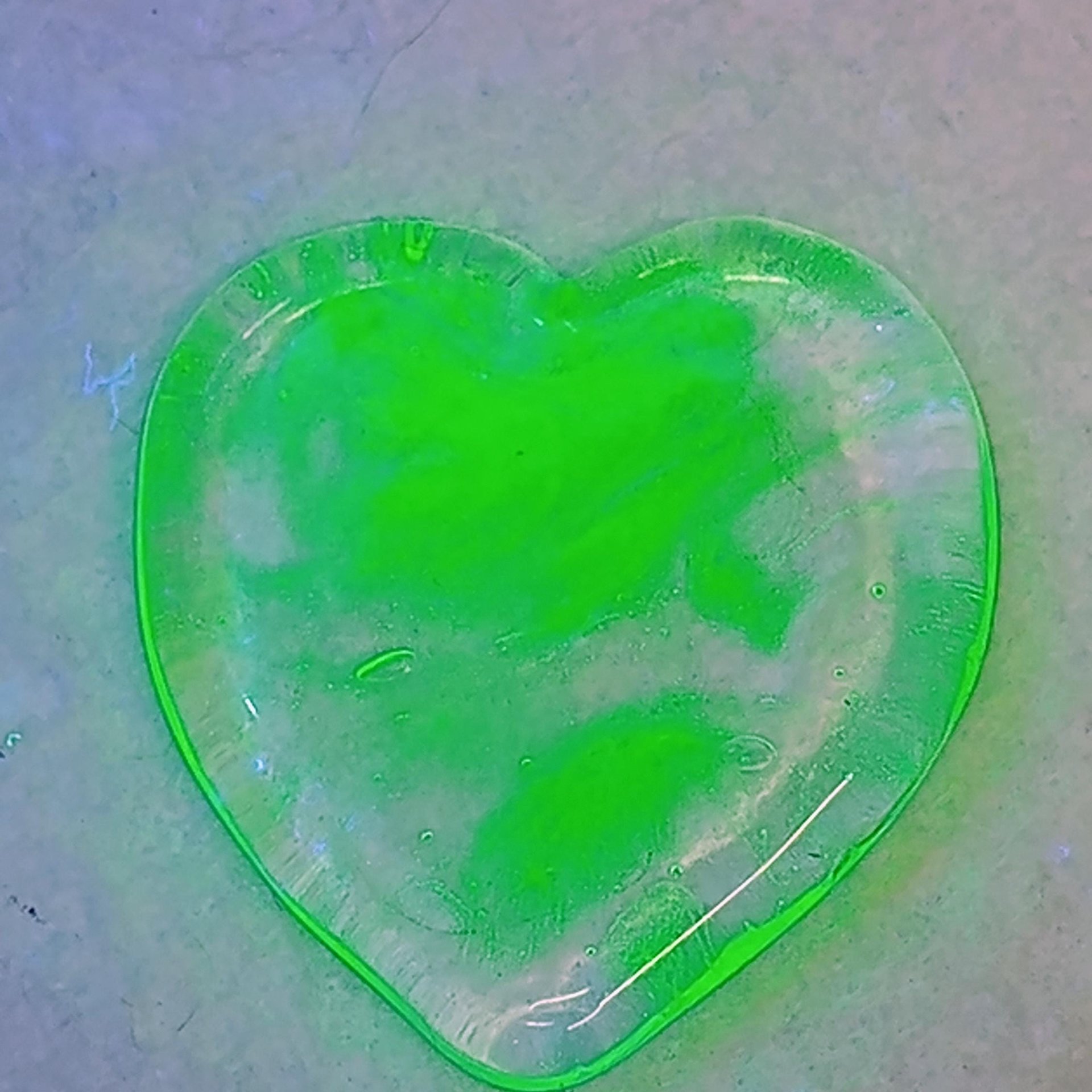 My Wispy Heart Glows! Uranium Large Heart  1" (25mm) clear glass with uranium swirls; This pocket heart is perfect for gift or curio display