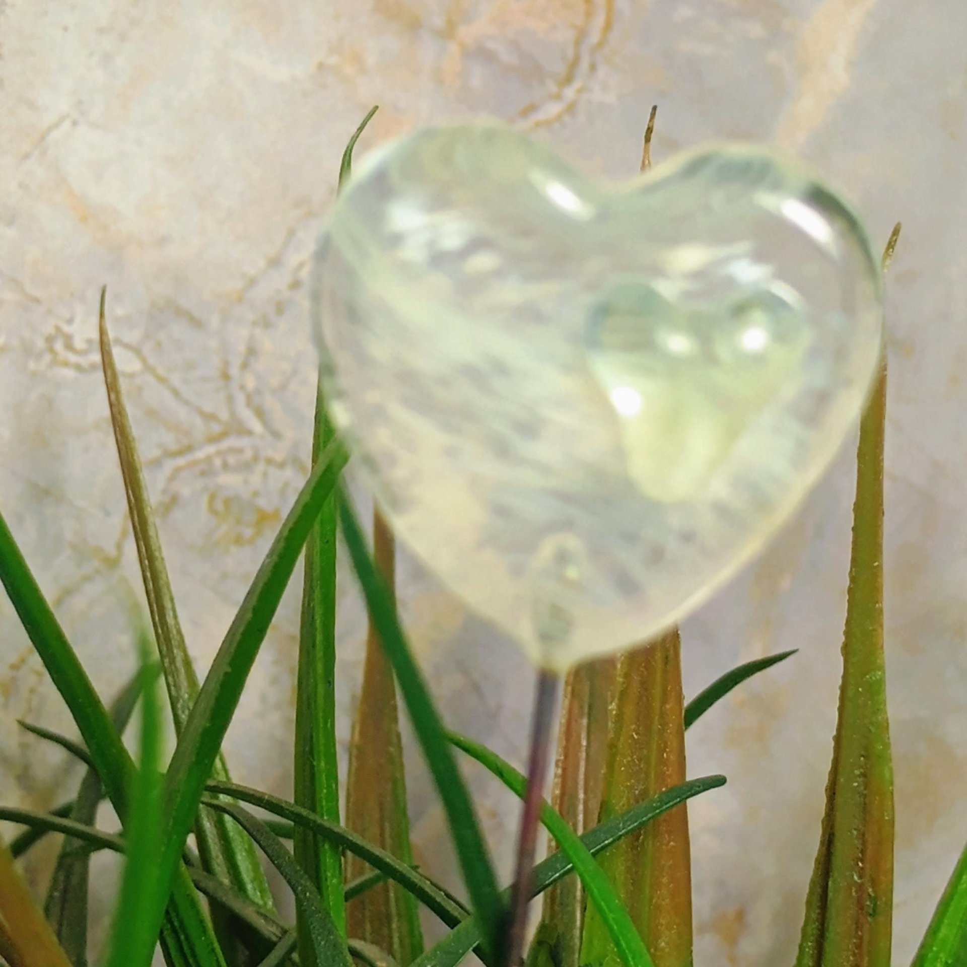 Wispy uranium vasoline glass on clear heart plant pick on 5in wire. Use for floral bouquet, plants, jewelry, gifts; handmade; 395nm