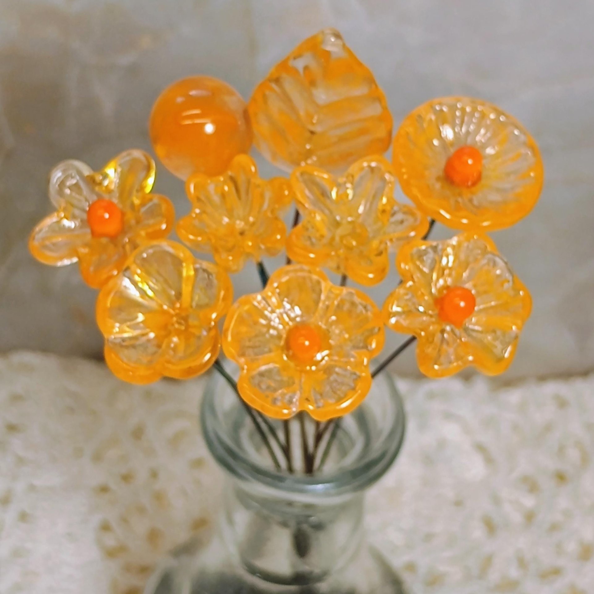 Tangerine glass flowers on wire headpins; juicy mix of clear and orange. Handcraft lampwork: jewelry, gifts, wedding, bouquets, mixed media