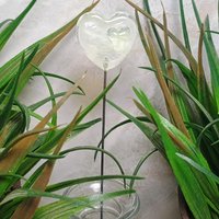 Wispy uranium vasoline glass on clear heart plant pick on 5in wire. Use for floral bouquet, plants, jewelry, gifts; handmade; 395nm