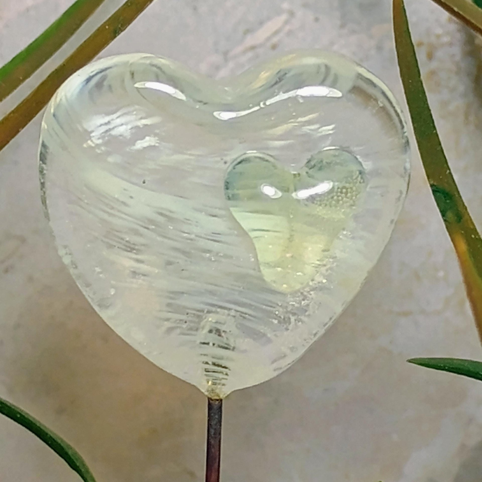 Wispy uranium vasoline glass on clear heart plant pick on 5in wire. Use for floral bouquet, plants, jewelry, gifts; handmade; 395nm